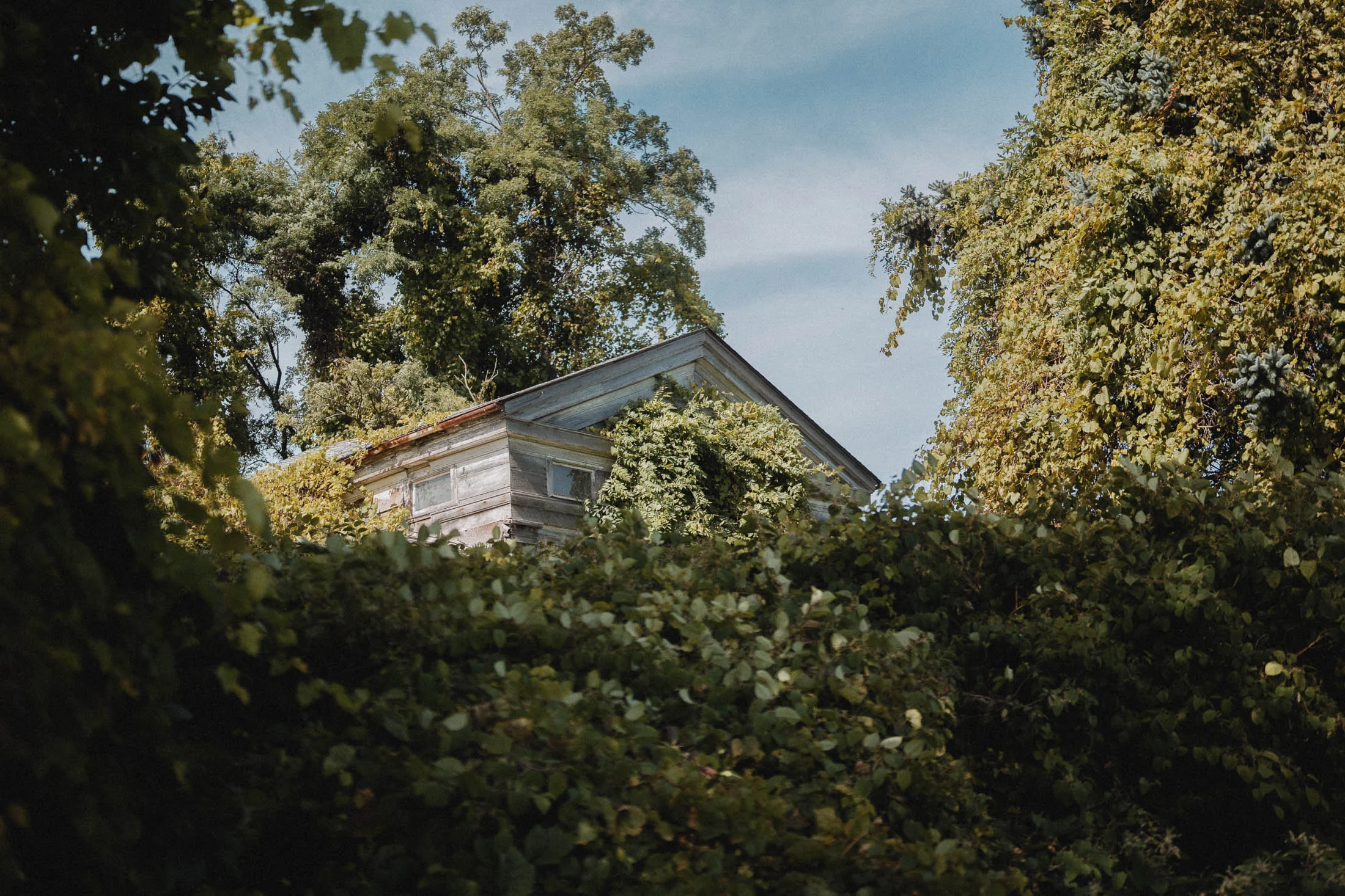 abandoned farmhouse exterior known as the Cadillac House in New York's Finger Lakes region