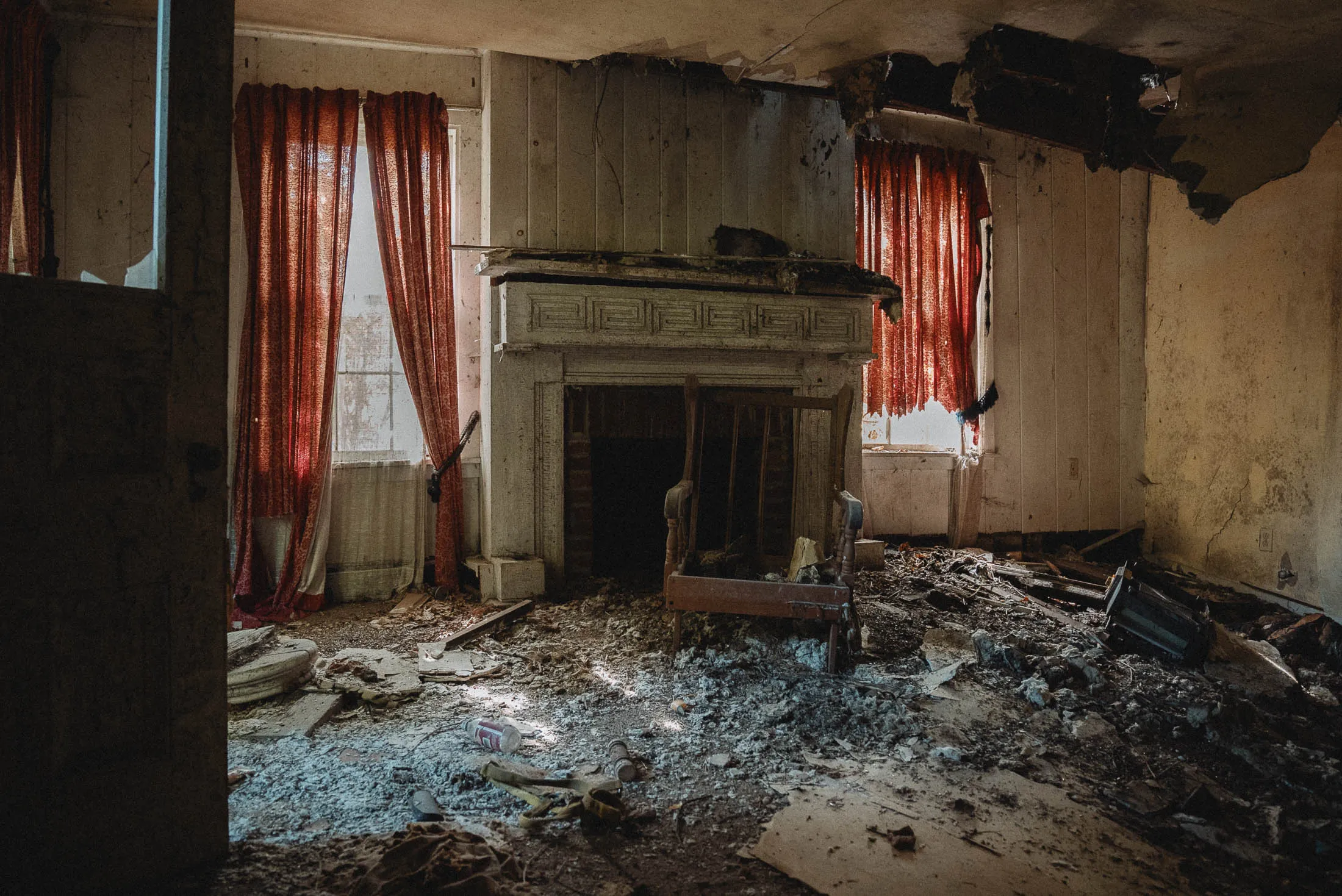 Collapsed living room featuring Greek Key fireplace surround, Cadillac House