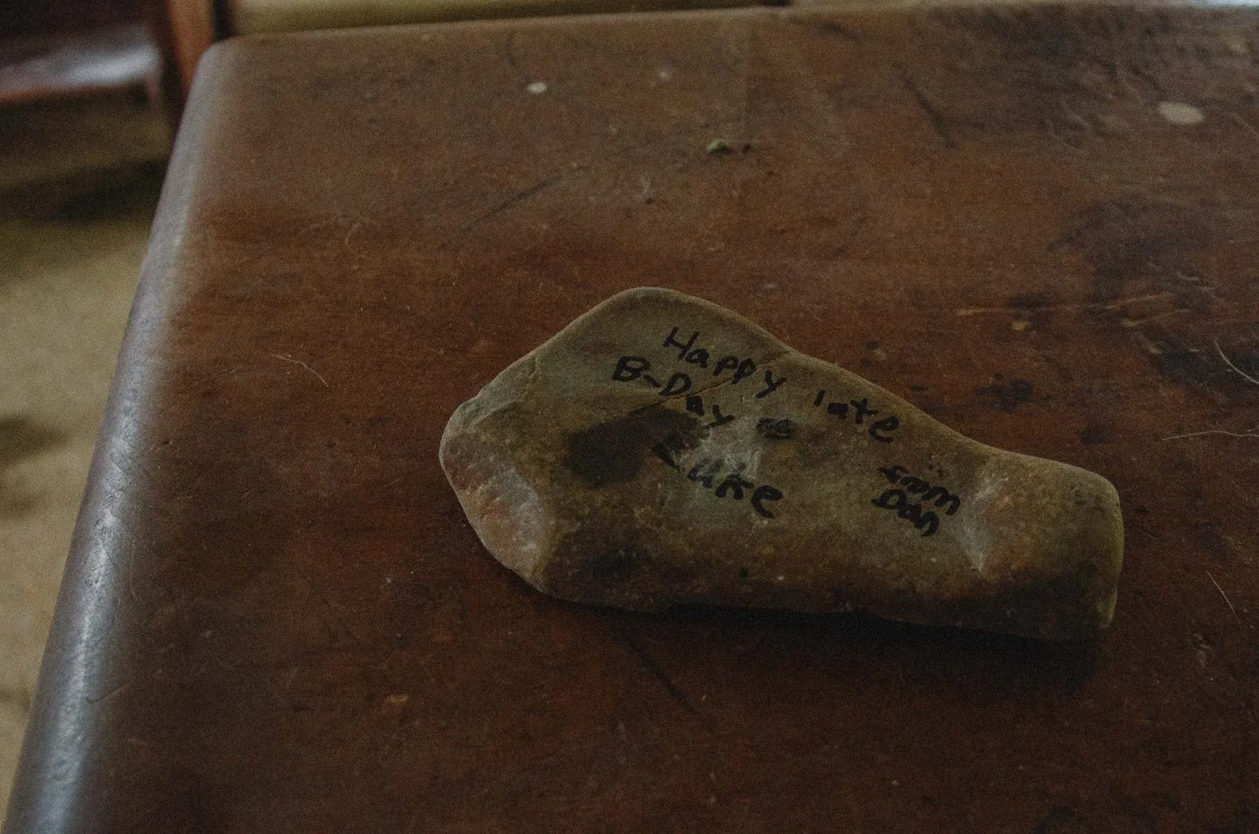 Keepsake birthday rock resting on a pew inside Cadis Baptist Church