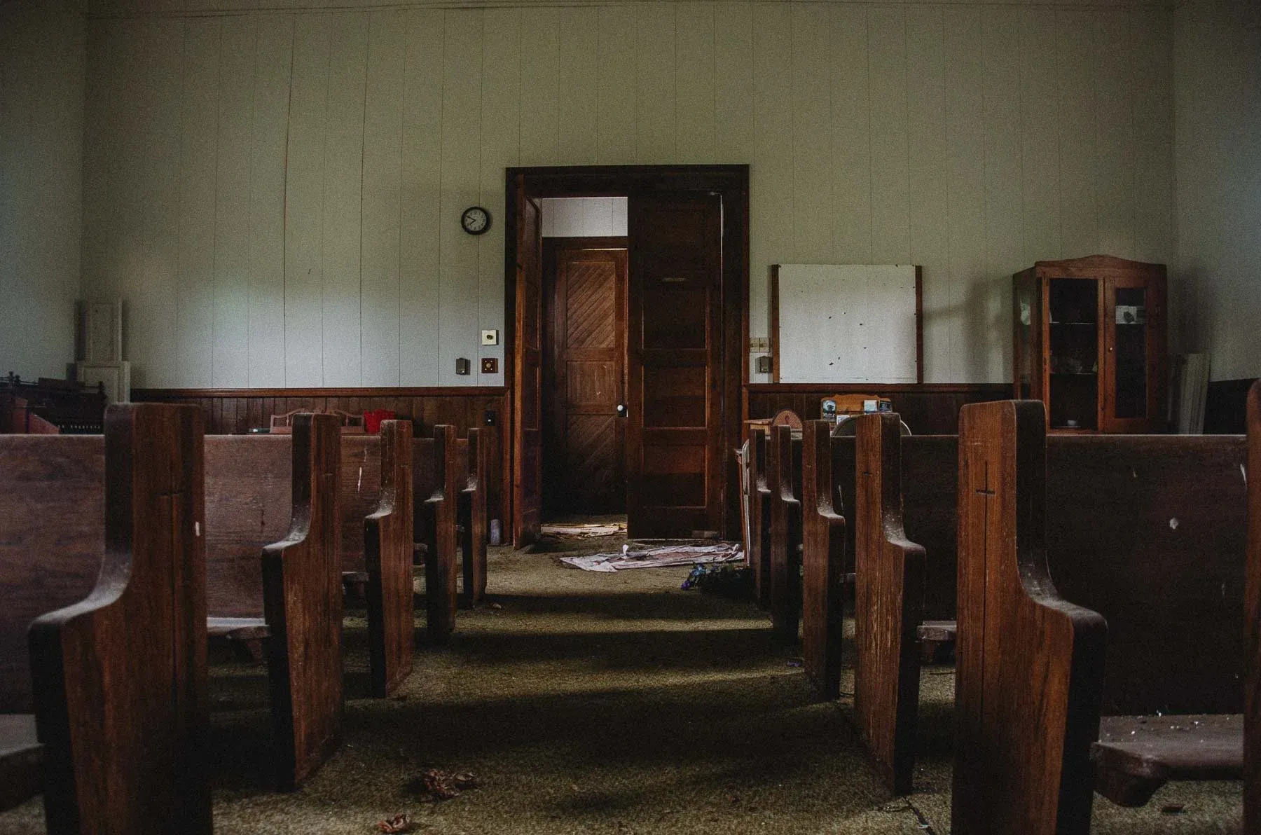 Handcrafted wooden pews aligned inside Cadis Baptist Church