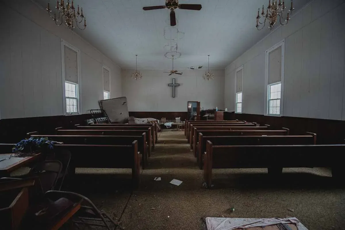 Sunlit sanctuary inside the abandoned Cadis Baptist Church