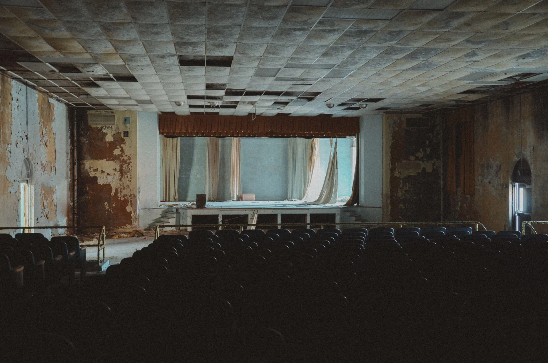 Abandoned auditorium stage inside Charlotte Kenyon Elementary School