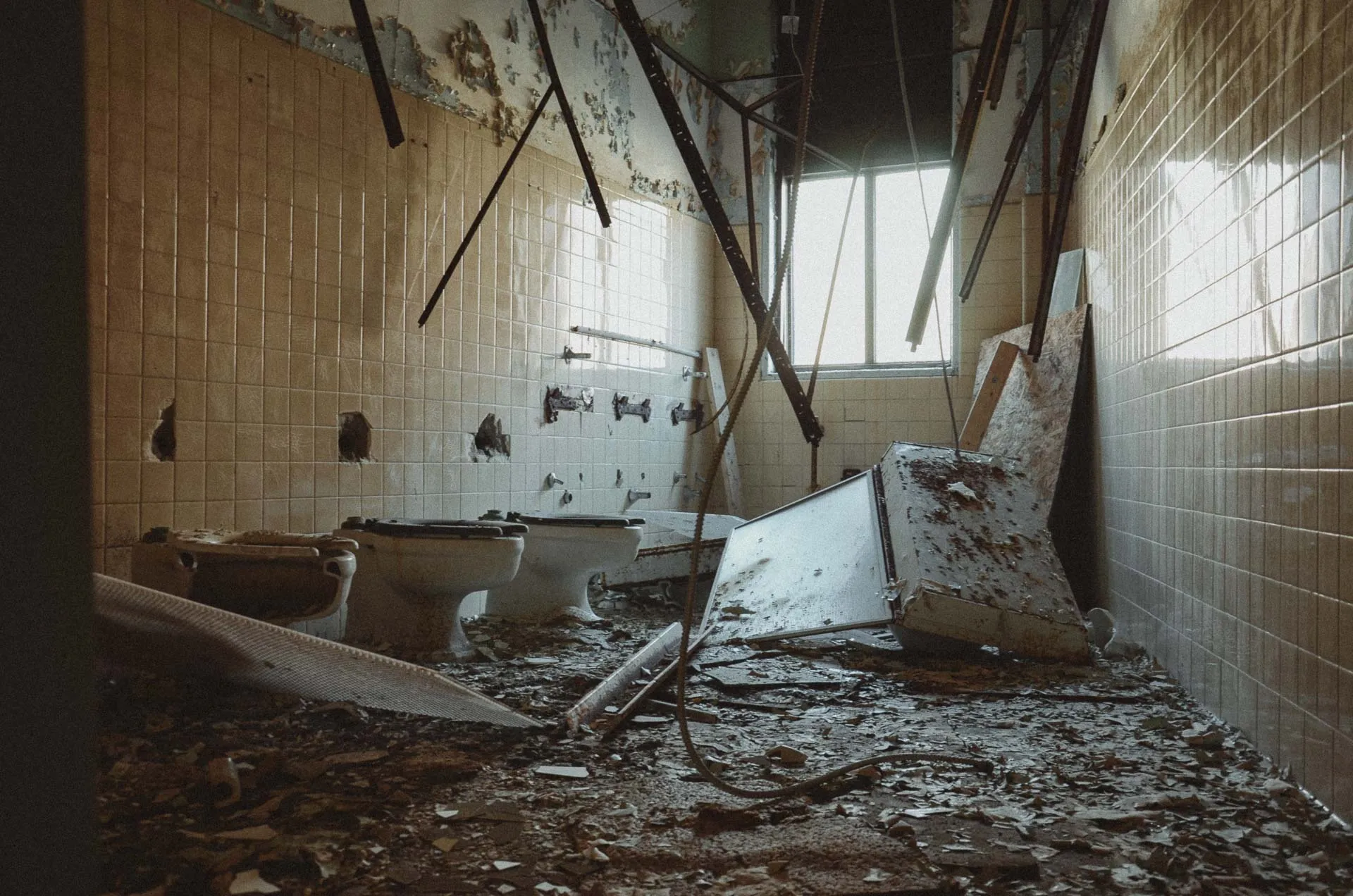 Sunlit boys' lavatory inside the abandoned Charlotte Kenyon Elementary School