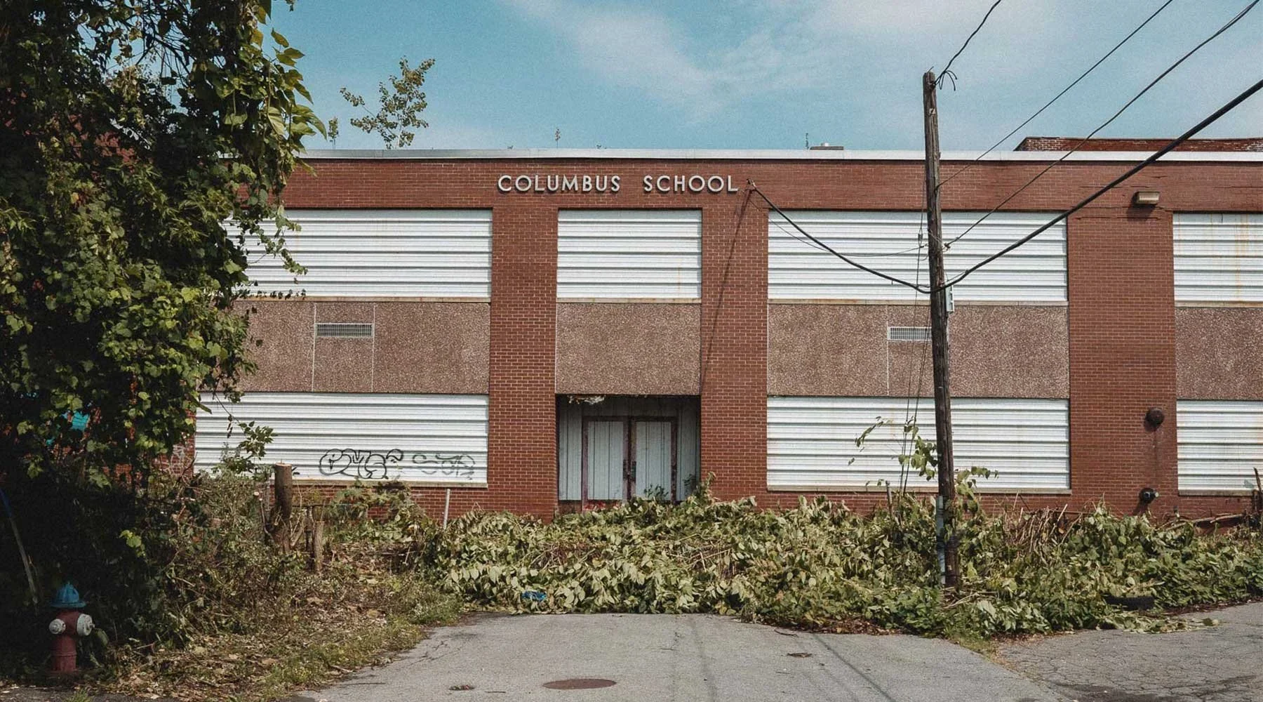 Exterior sign for the abandoned Columbus School in Rome, New York