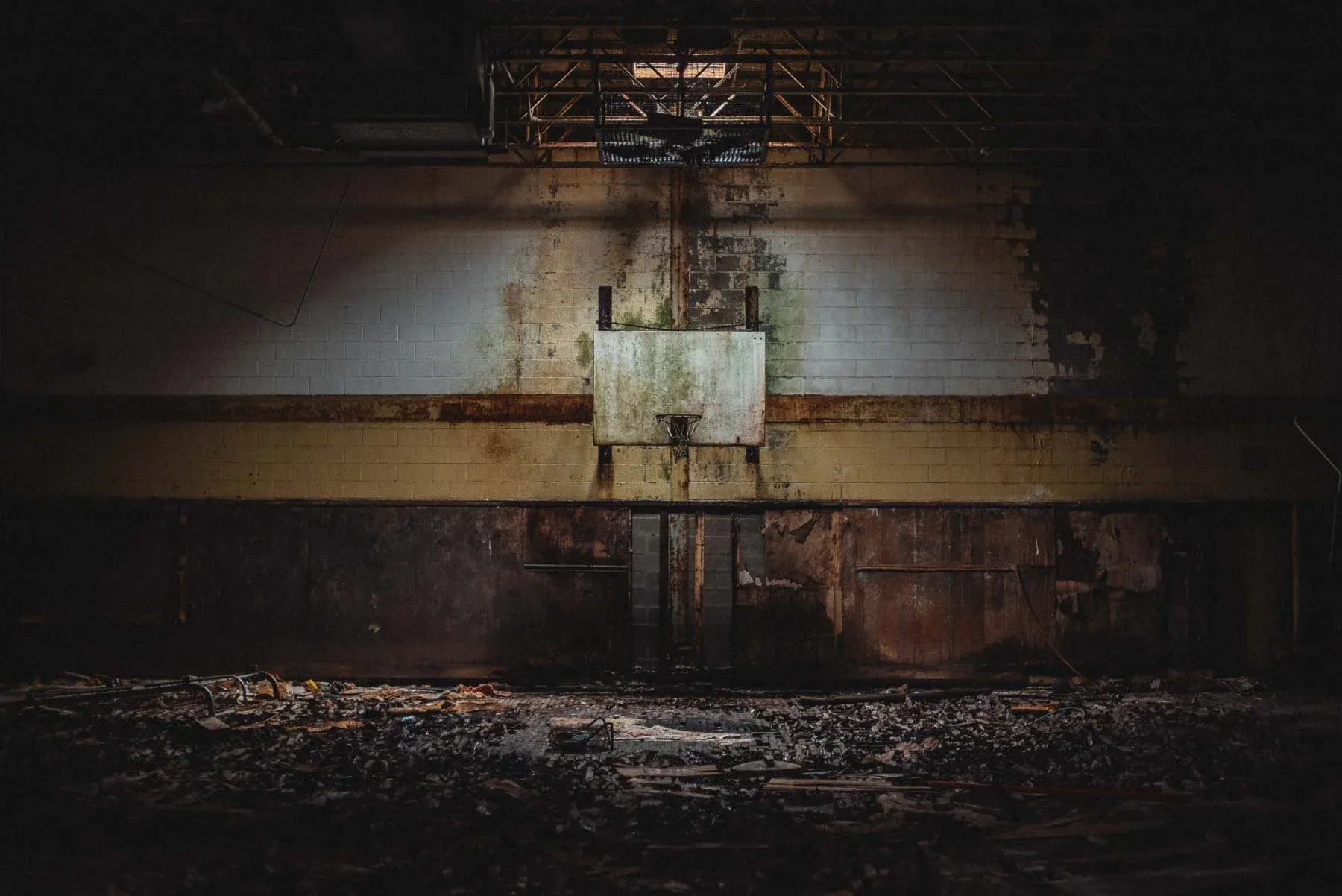 Columbus Cougars basketball hoop inside the abandoned Columbus School gymnasium