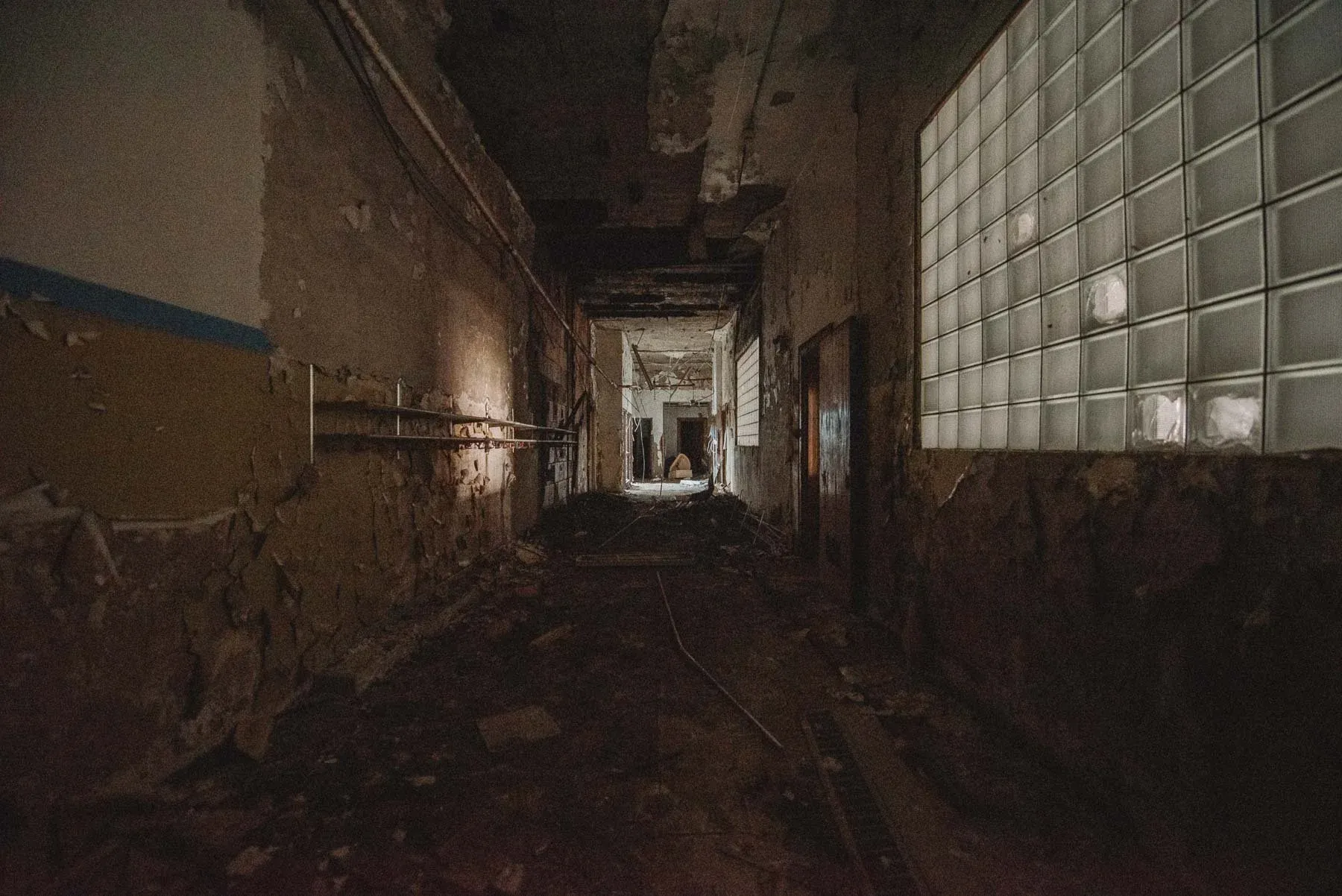 Hallway lined with coat hooks inside the abandoned Columbus School