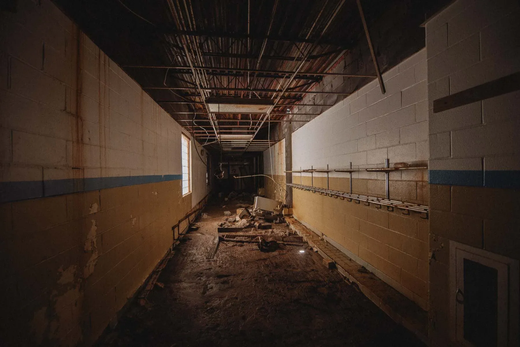 Water-damaged hallway on the lower level of the abandoned Columbus School