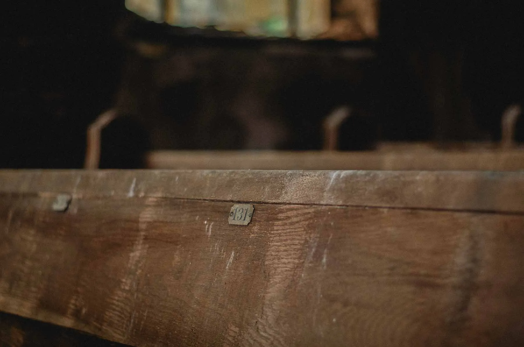 Numbered pew 131 along the sanctuary aisle