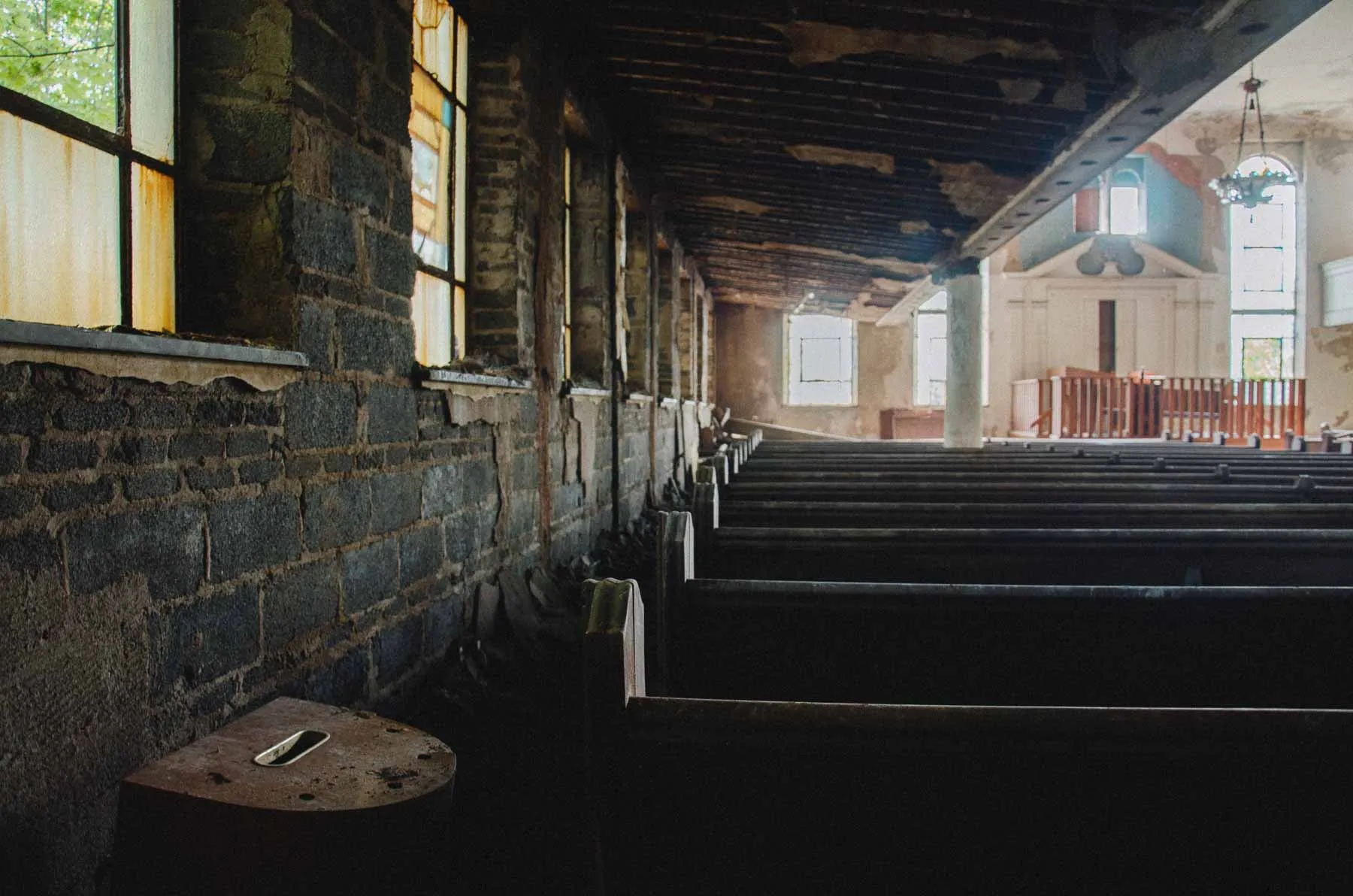 Main floor pews inside Congregation B'Nai Israel showing years of neglect