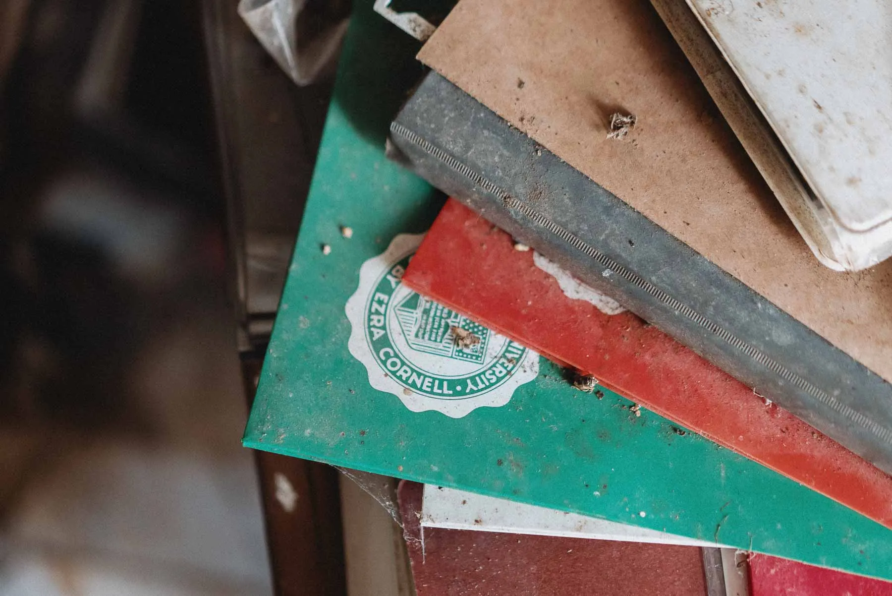 Green Cornell folder covered in dust inside the barndominium