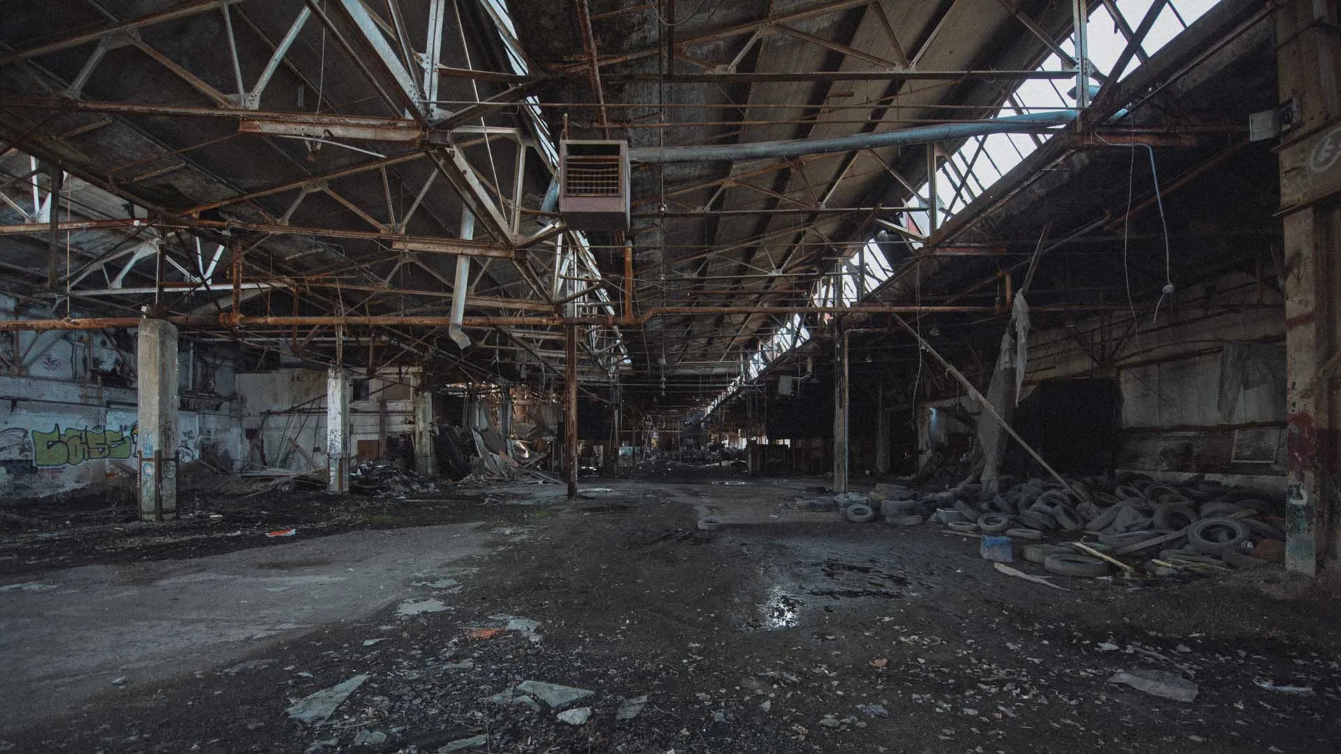 Wide interior view of the D.W. Winkelman Co. warehouse with open bays and debris