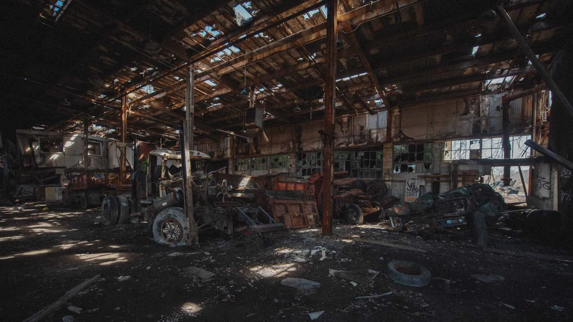 Heavy trucks left behind inside the abandoned D.W. Winkelman Co. warehouse