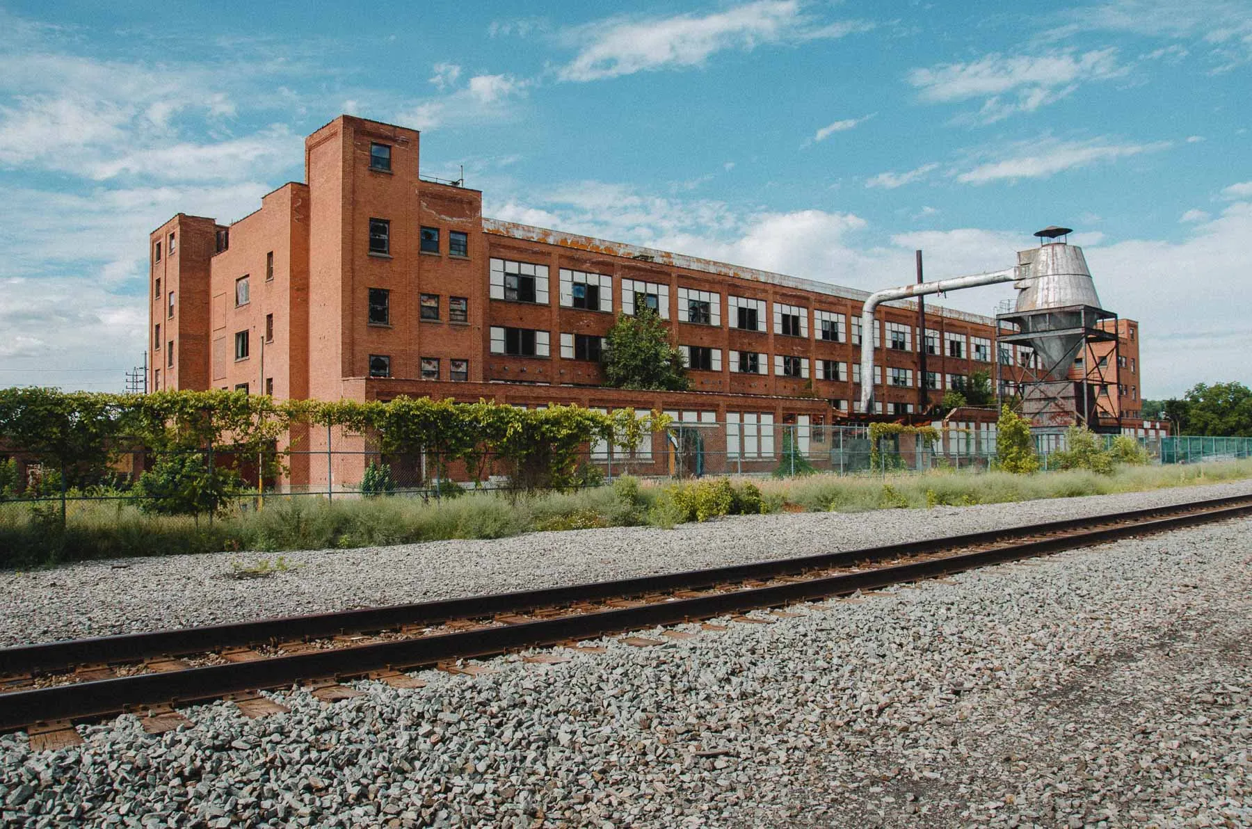 Broad exterior facade of the Fair Play Factory with multi-level stair tower
