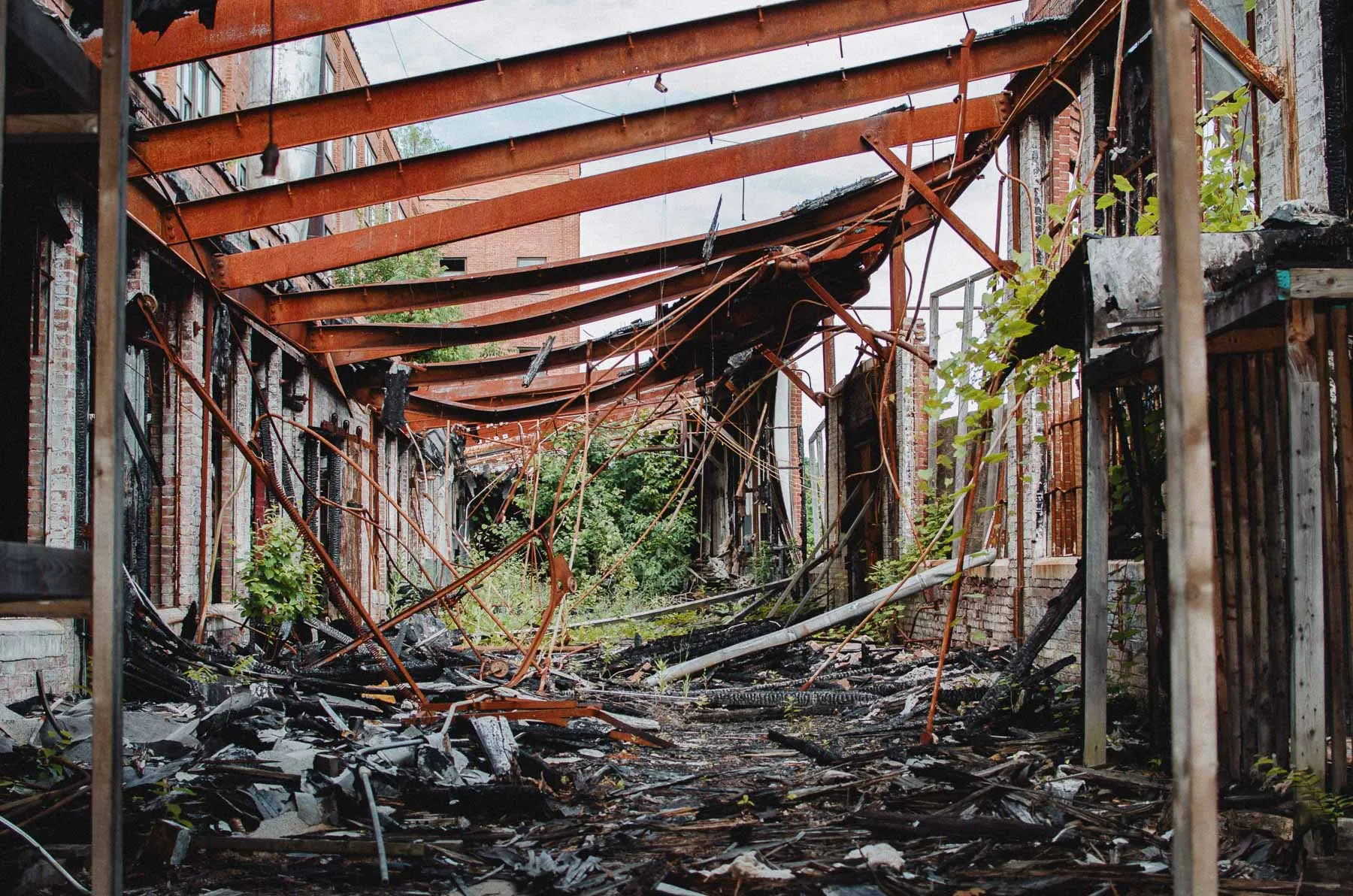 Fire-damaged stairwell with charred walls and beams inside the Fair Play Factory