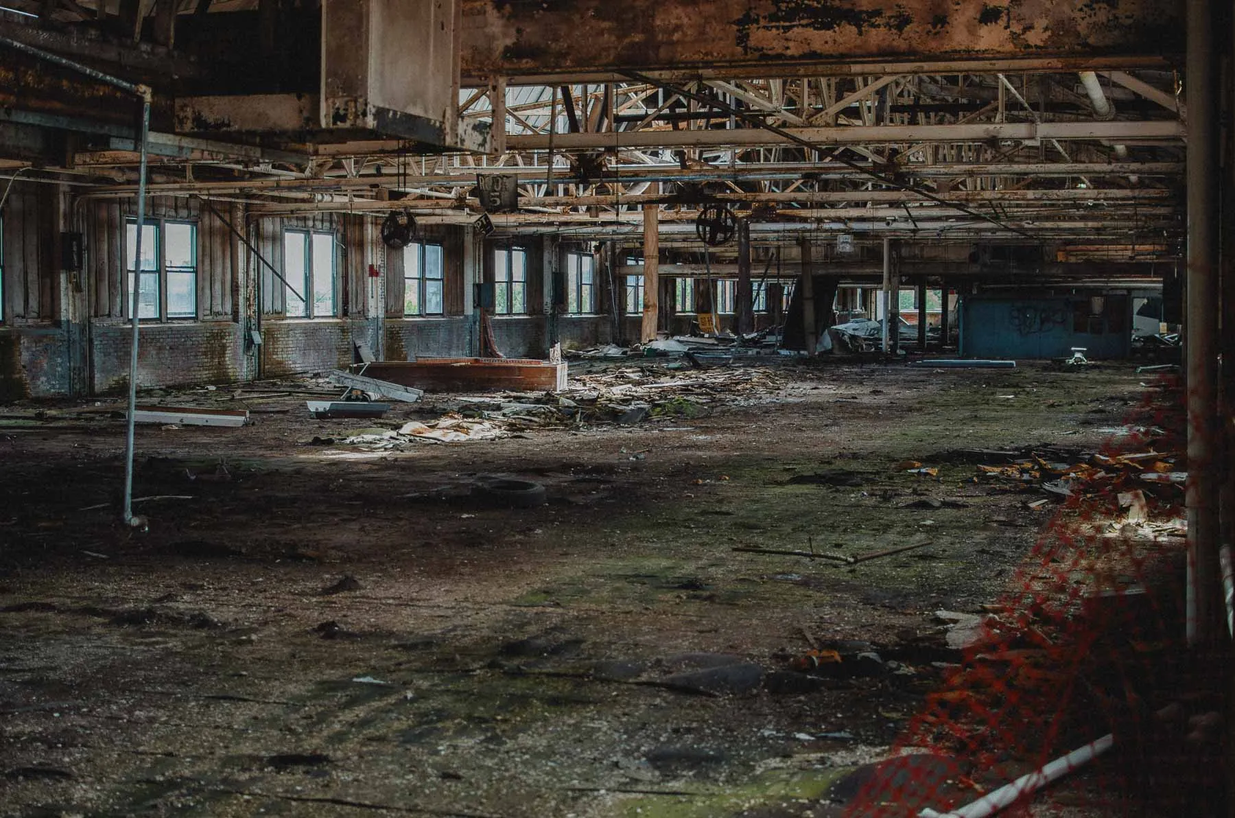 Fourth-floor die cut room with debris and daylight streaming through tall windows