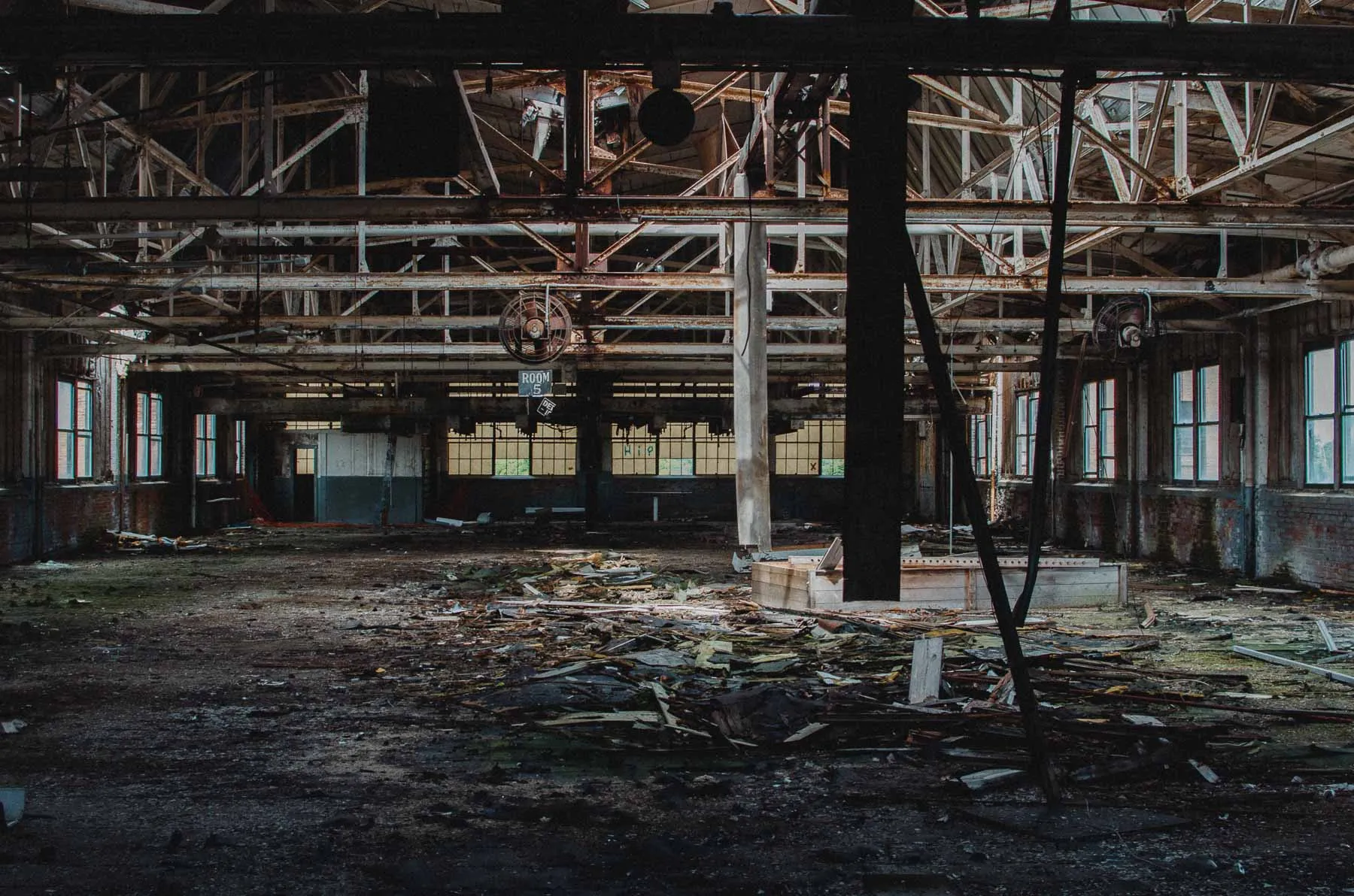 Room 5 production floor inside the Fair Play Factory with scattered debris