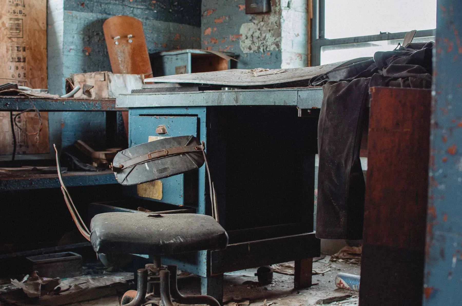 Workshop desk and hand tools staged along a stairwell landing inside the Fair Play Factory