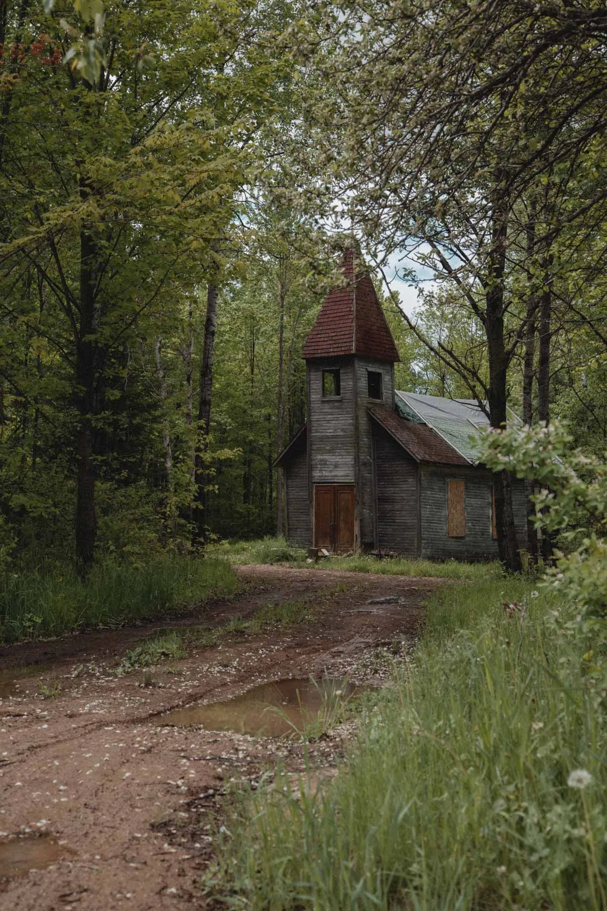Abandoned Estonian Evangelical Martin Luther Church surrounded by trees in Gleason, Wisconsin