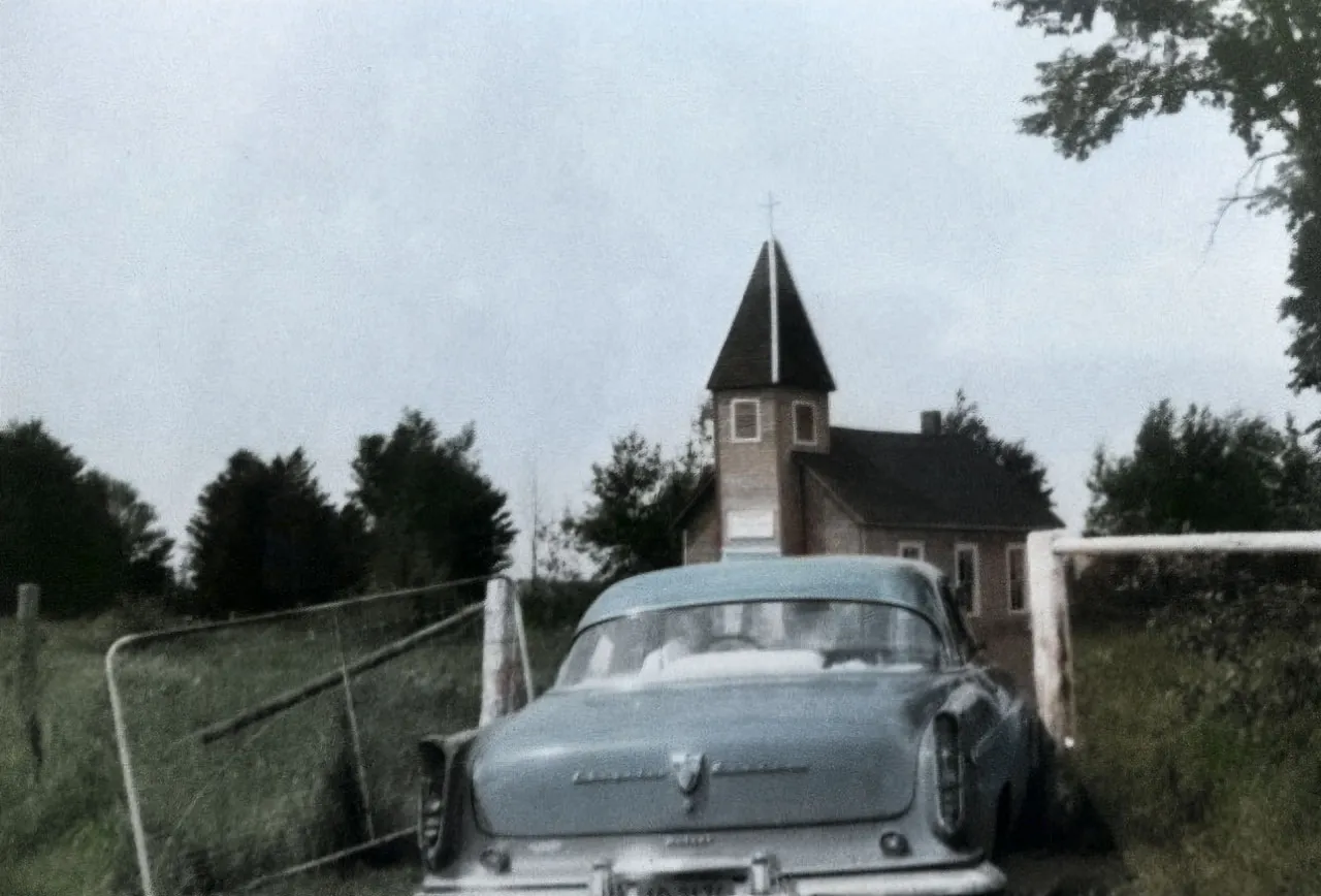 Historic postcard view of the Estonian Evangelical Martin Luther Church with a parked car