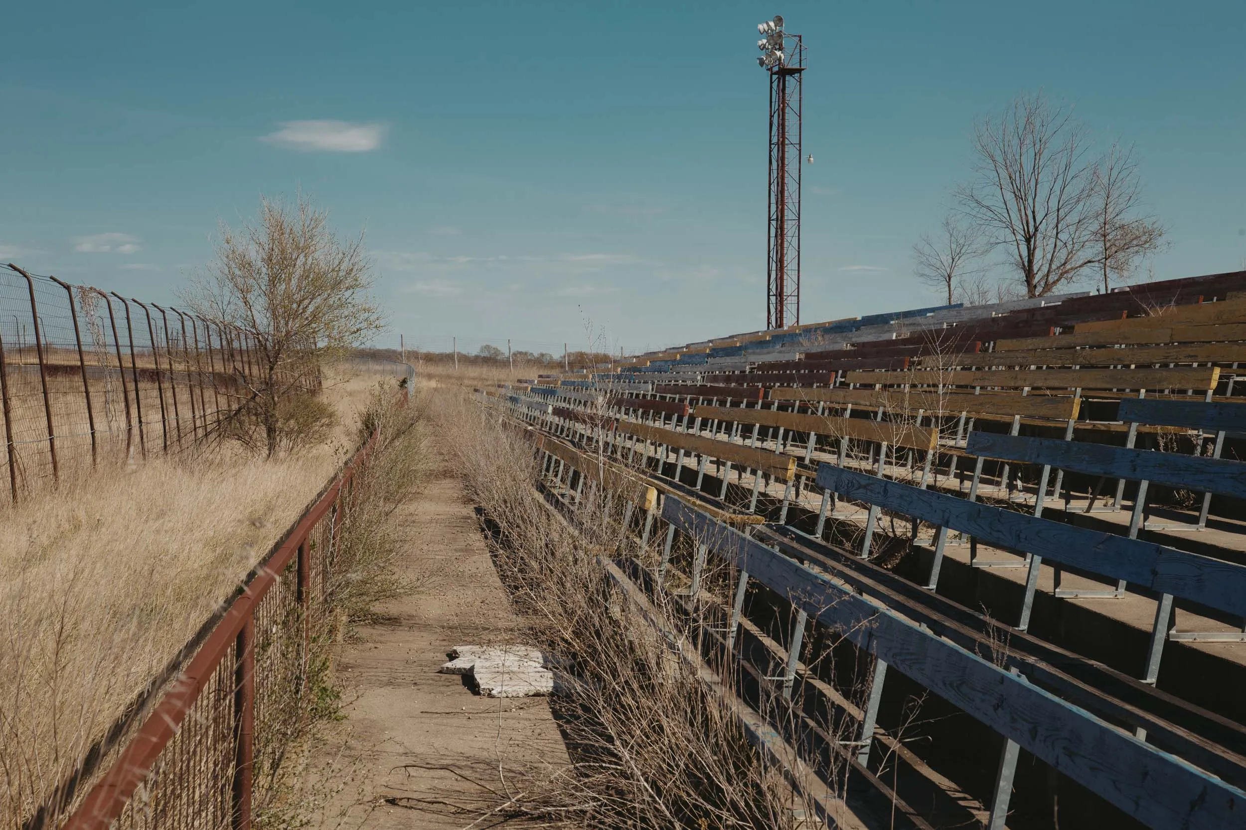 Overgrown grass surrounding the backstretch bleachers at I-94 Speedway