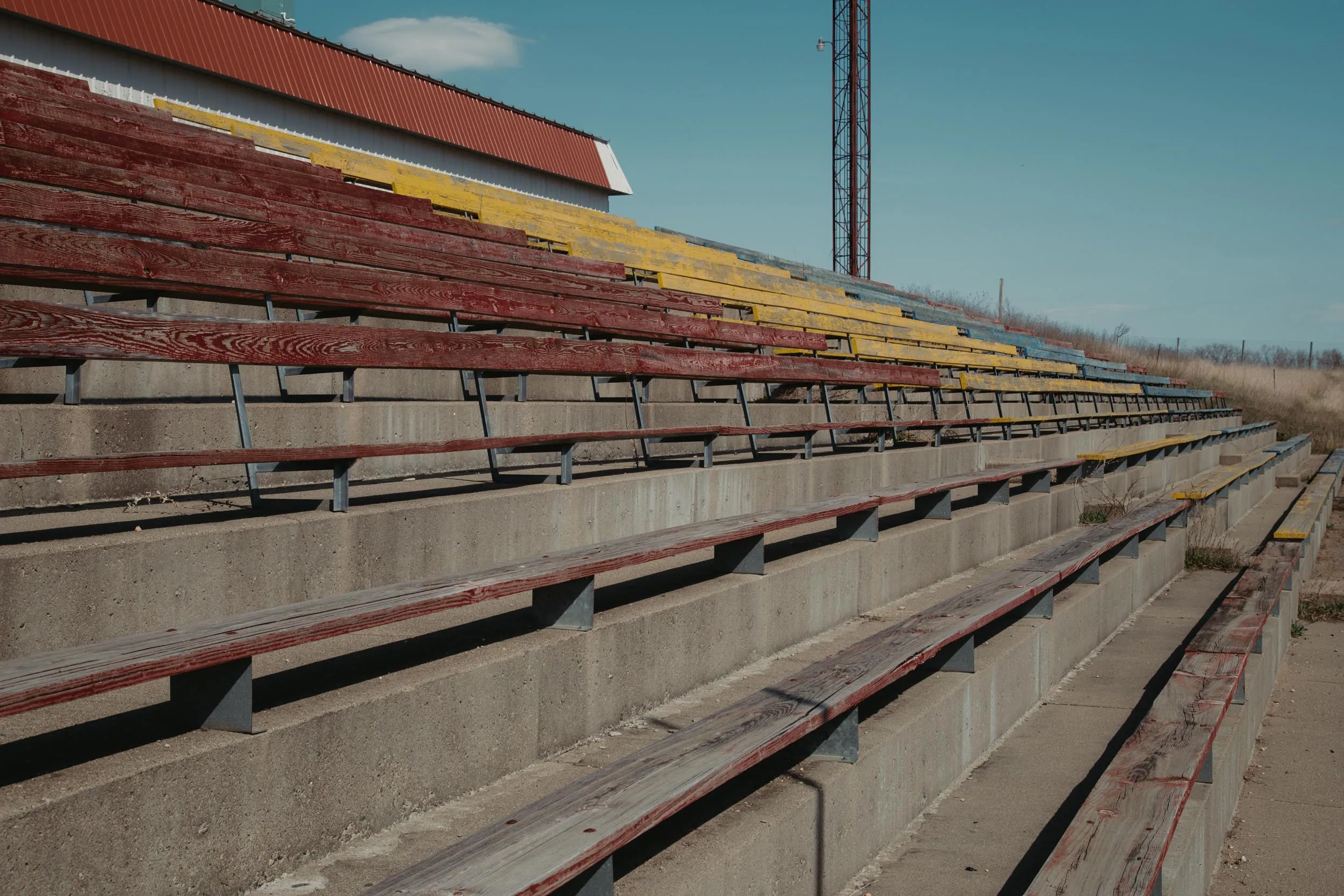 Weathered red-painted grandstand seating at the abandoned I-94 Speedway