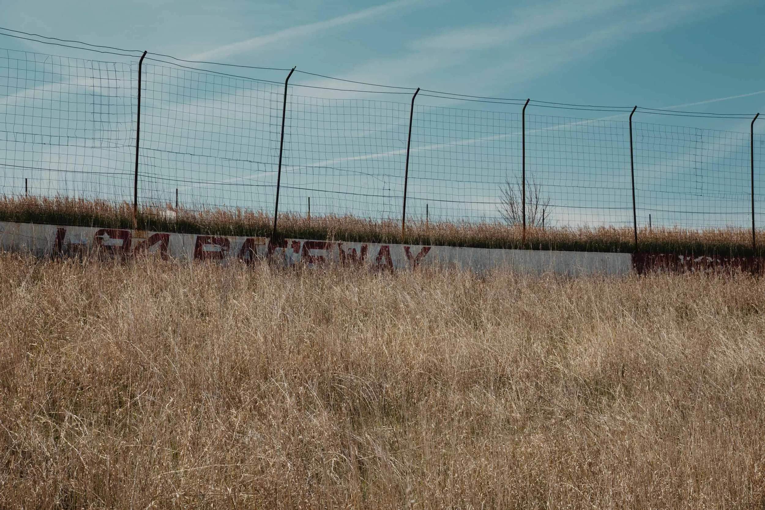 Concrete track wall painted with the I-94 Speedway logo