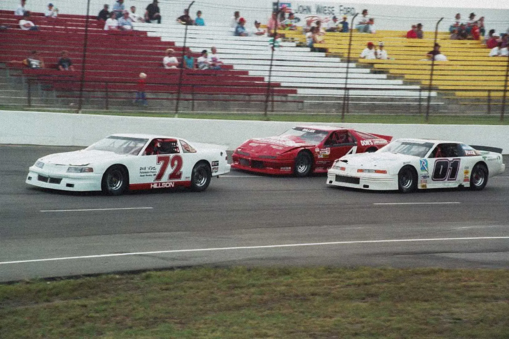 Stock cars battling for position on the I-94 Speedway front stretch