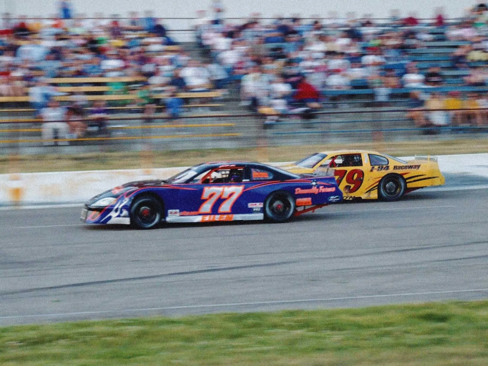 Late model stock cars lined up along pit road at I-94 Speedway