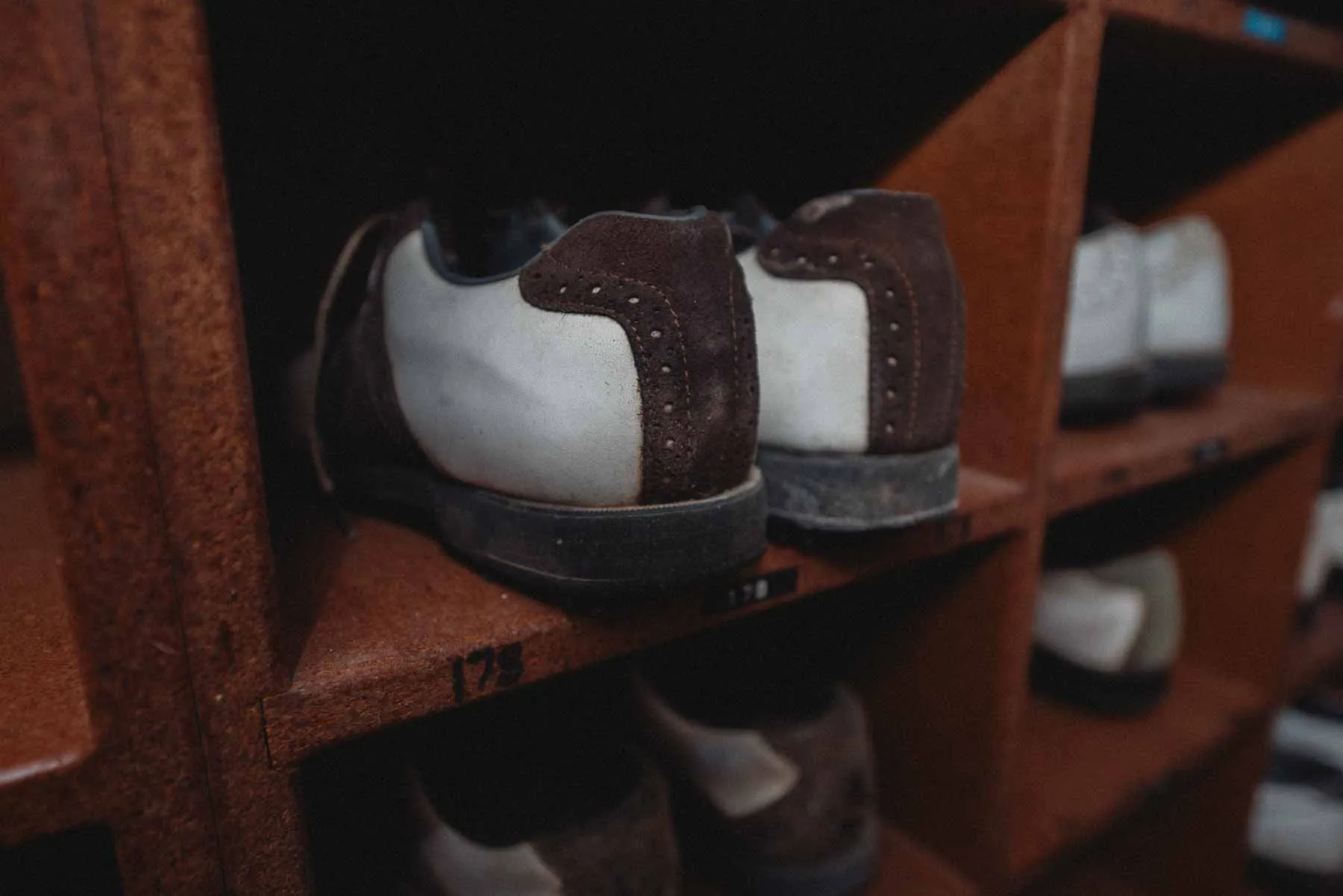 Rows of abandoned golf shoes on the pro shop floor at LaFayette Hills