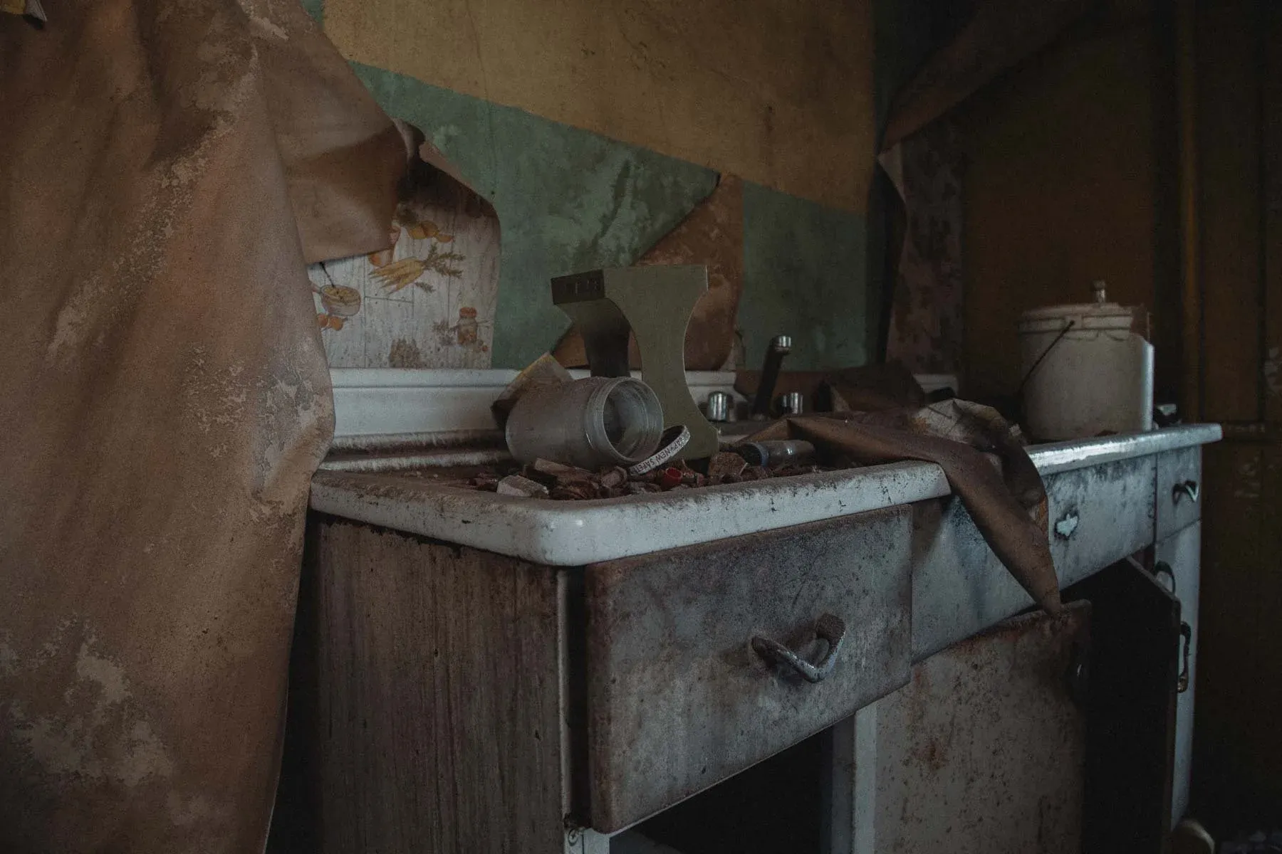 Porcelain drainboard kitchen sink with peeling wallpaper at Landwehr Century Farm