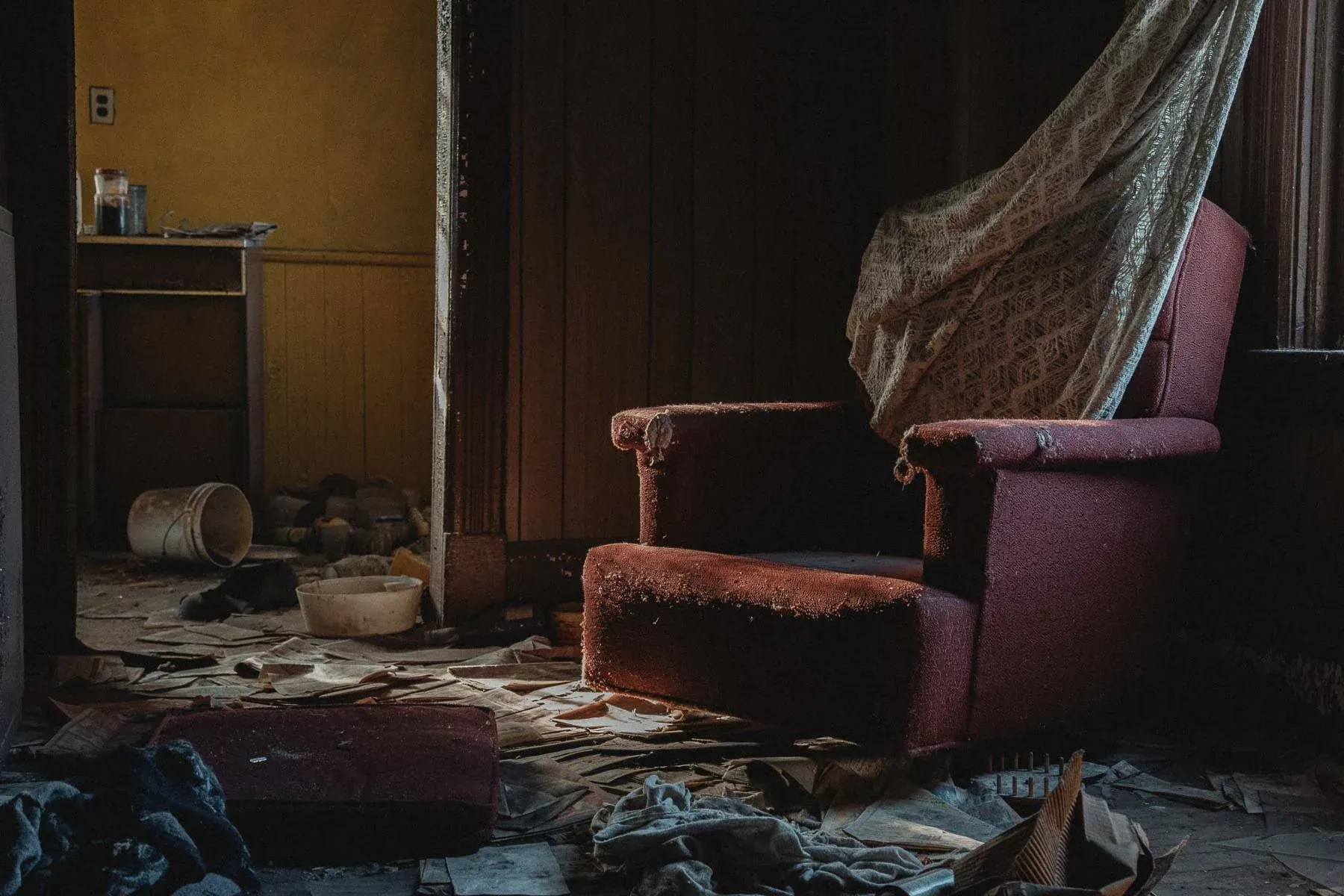 Red armchair draped in lace curtains inside Landwehr Century Farm