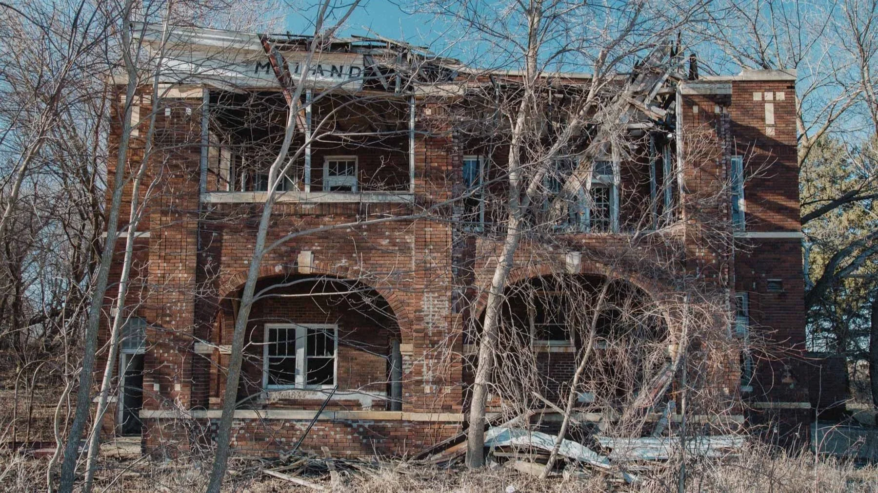 Crumbling brick exterior of Moland Creamery in Moland, Minnesota