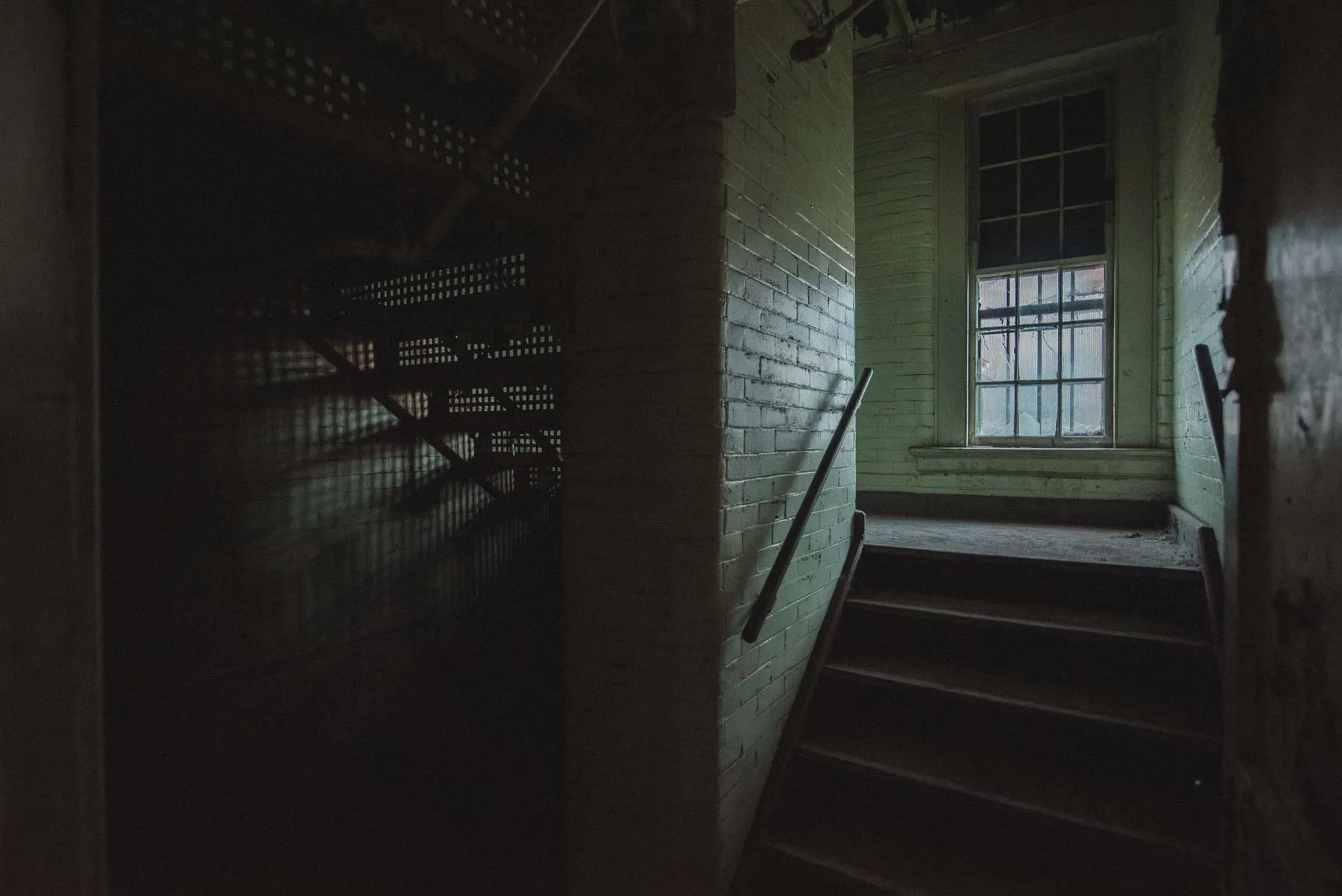 Green split landing staircase inside the Richardson Olmsted Complex