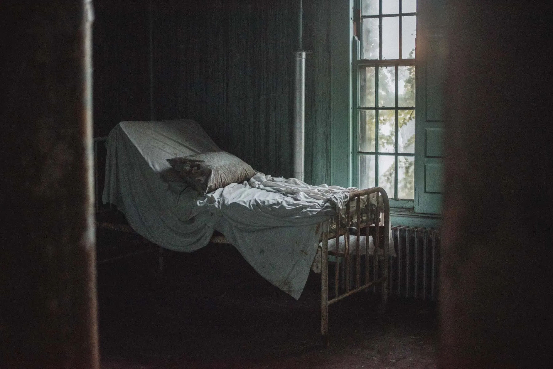 Hospital bed amid peeling paint inside the Richardson Olmsted Complex