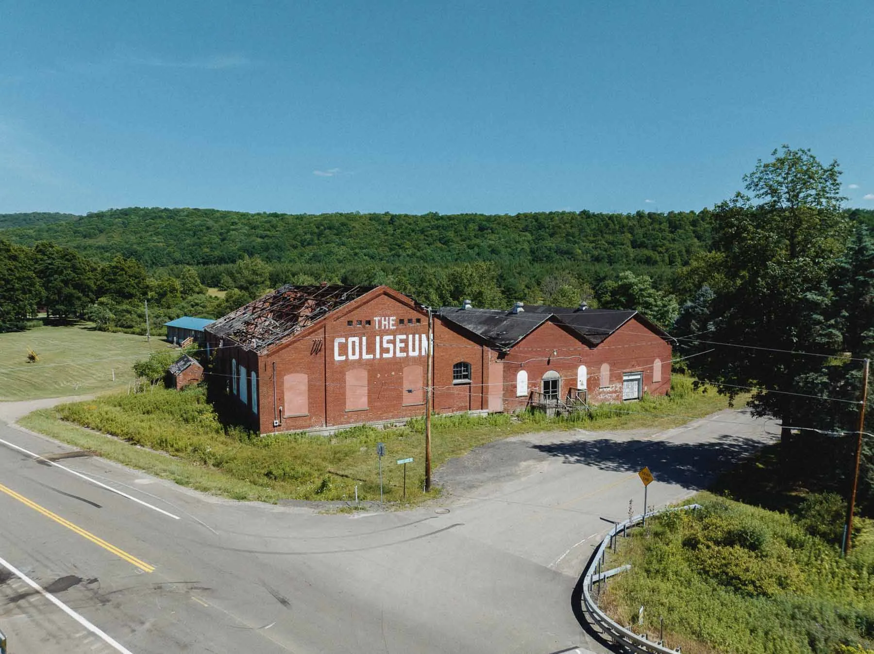 2022 drone photograph showing collapsed roof of The Coliseum roller rink, Ceres NY