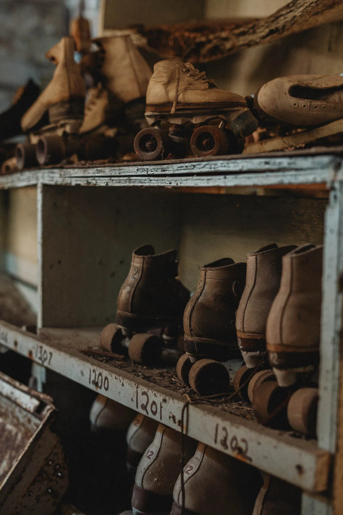 Group of toddler-sized roller skates inside the abandoned rink in Upstate NY