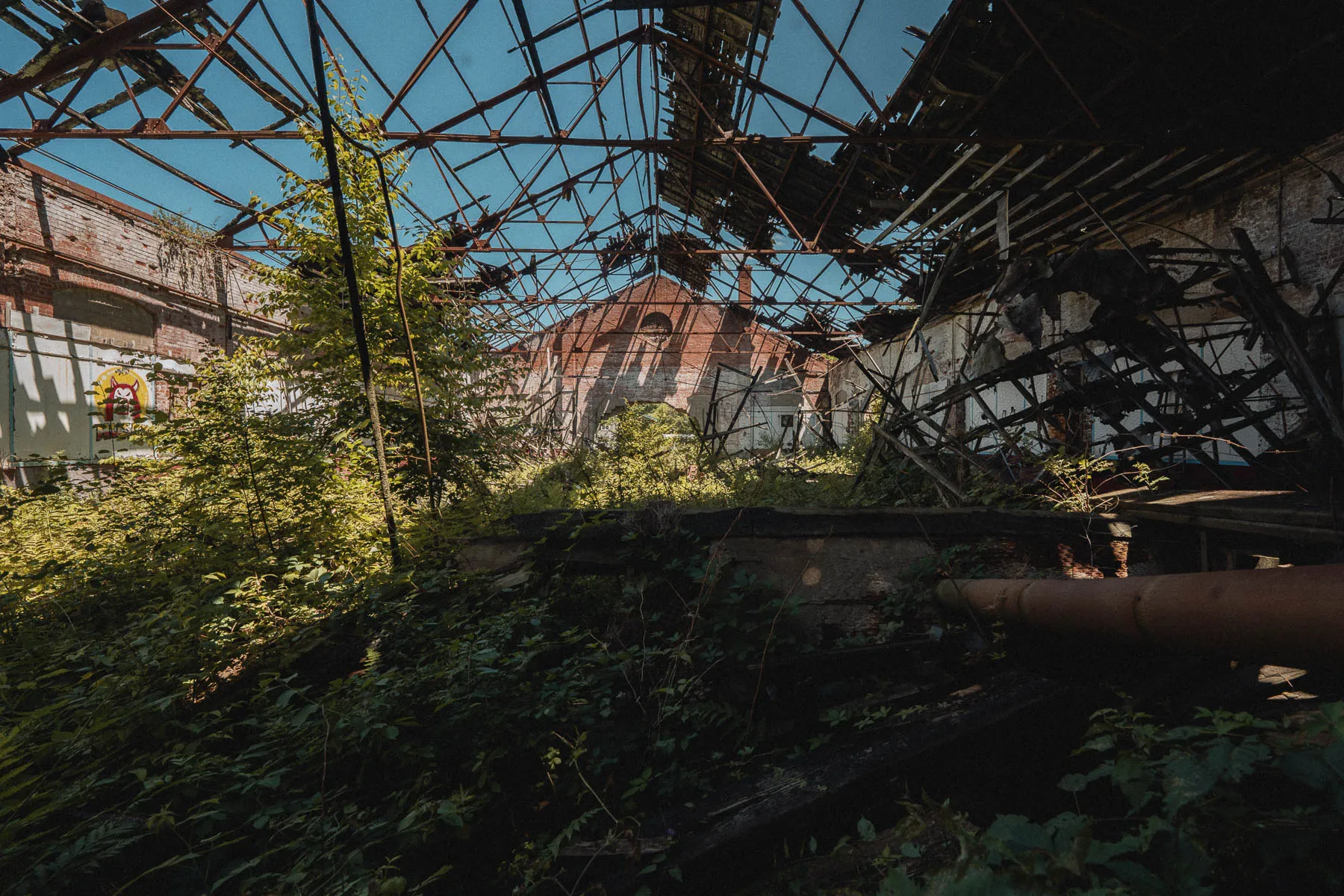 Collapsed roller rink with semi-truck impact damage on the north brick wall