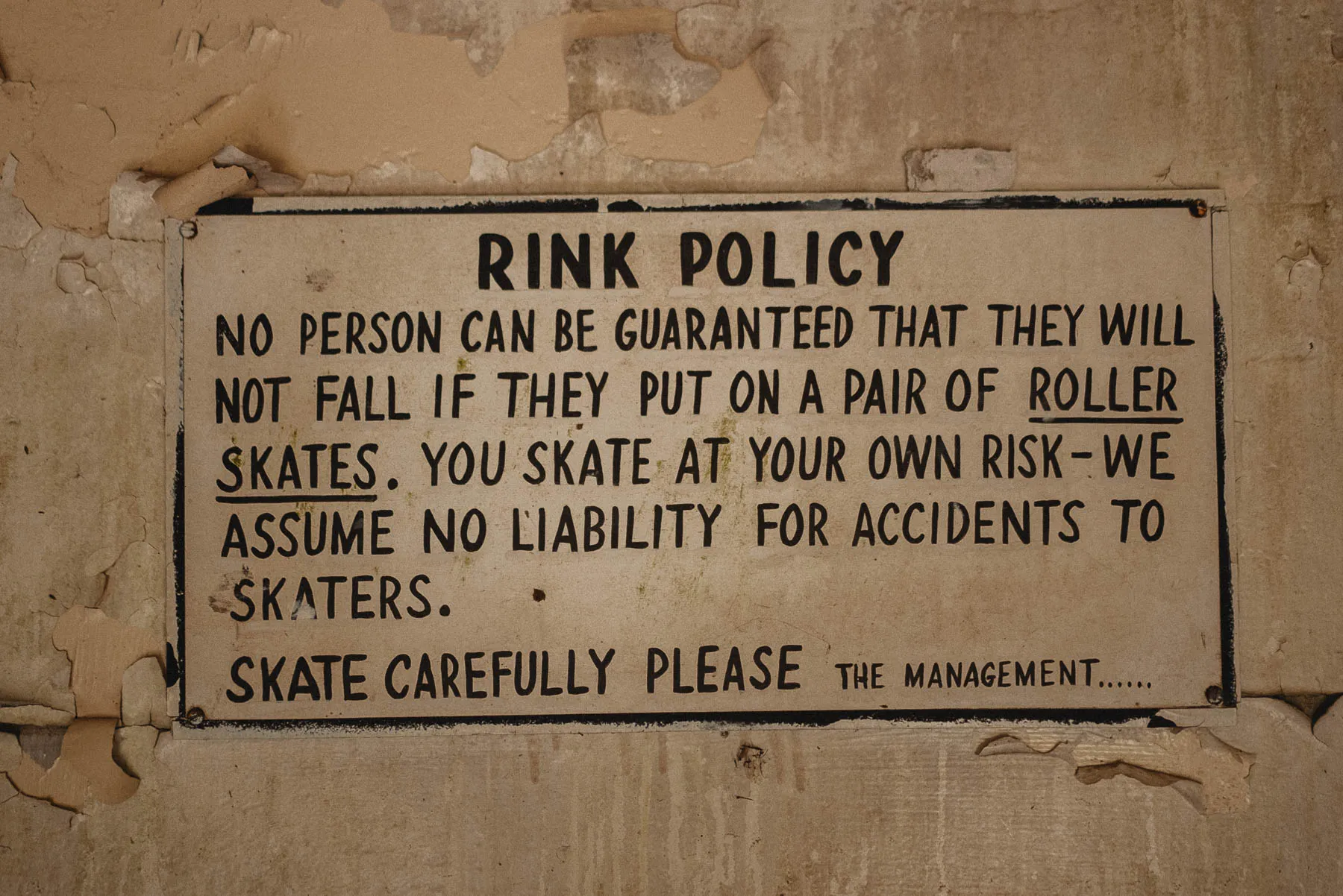 Hand-painted “Skate at Your Own Risk” sign inside The Coliseum, Ceres NY