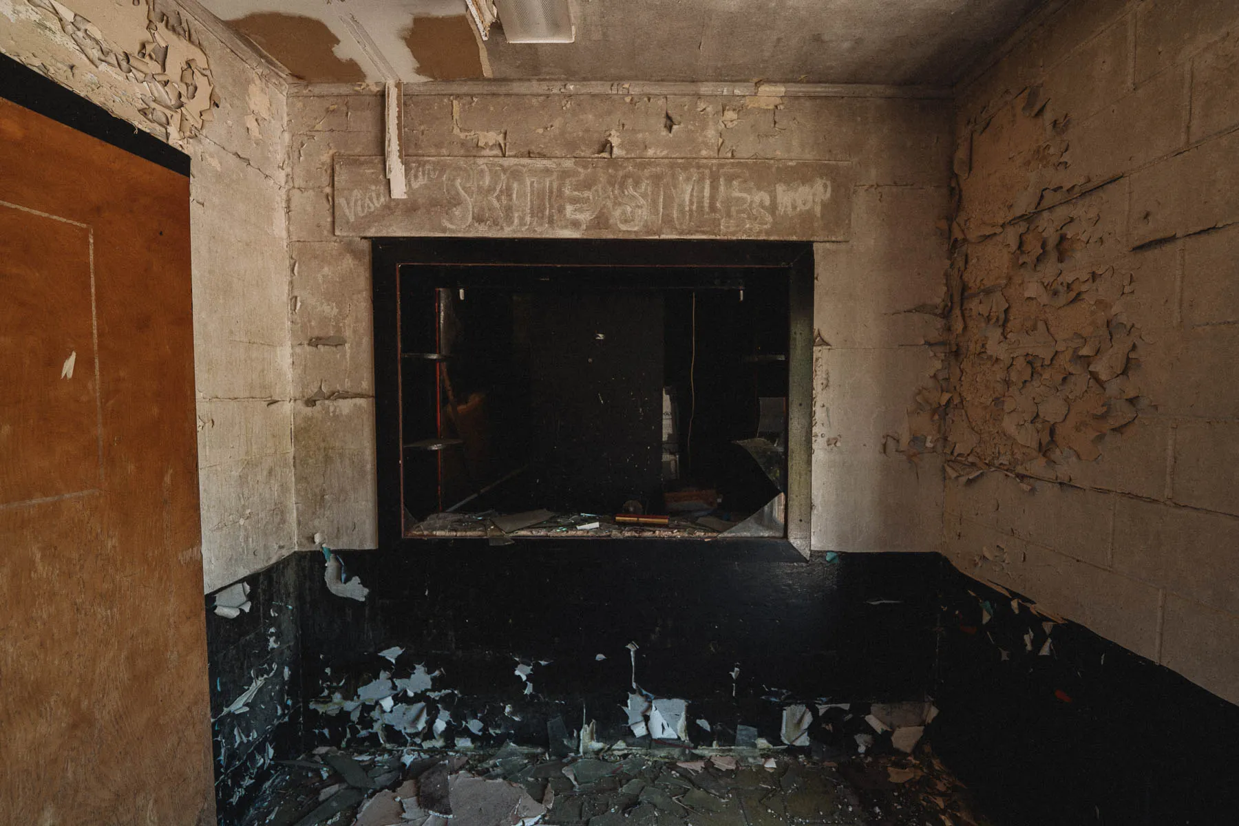 Faded “Skate Style Shop” sign inside the abandoned Coliseum roller rink, WNY