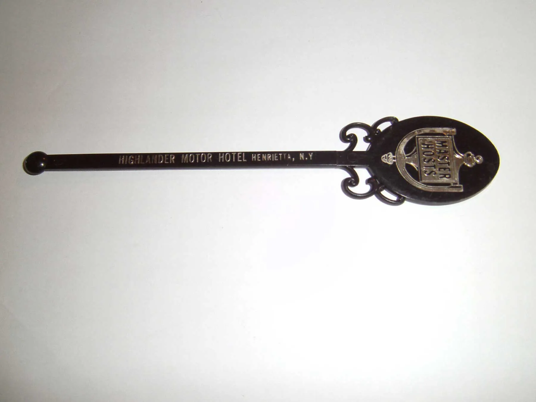 Souvenir swizzle stick from the Highlander Motor Hotel, predecessor to Vista Heights Inn