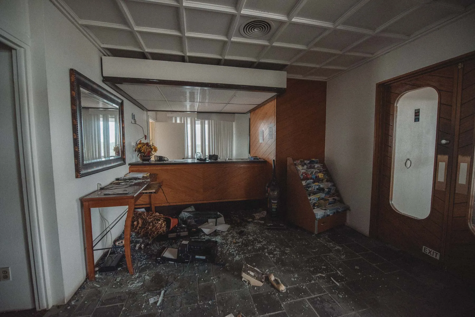 Front desk covered in paperwork inside the abandoned Vista Heights Inn