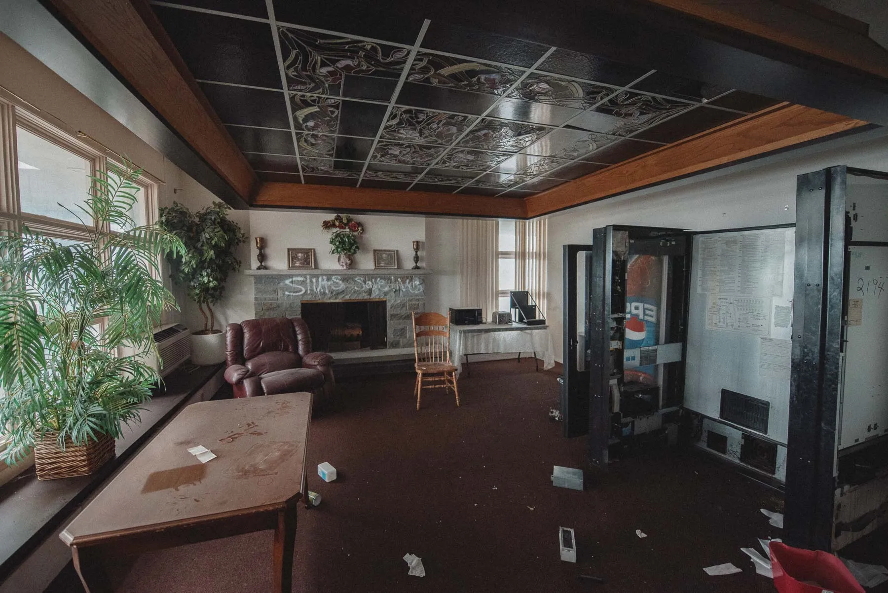 Lobby desk and retro wall art inside the abandoned Vista Heights Inn