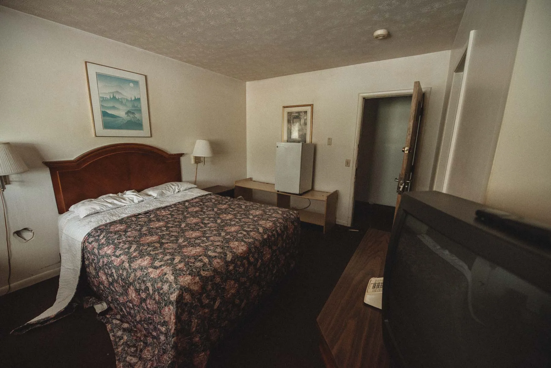 Guest room with stripped beds inside the abandoned Vista Heights Inn