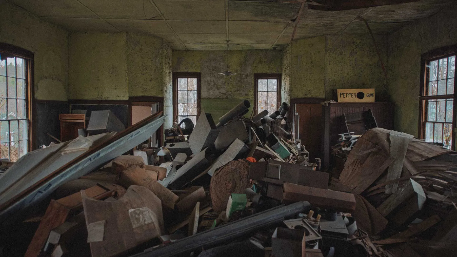 Main classroom of the 1880 Wiscoy School cluttered with stored materials and separate entrances