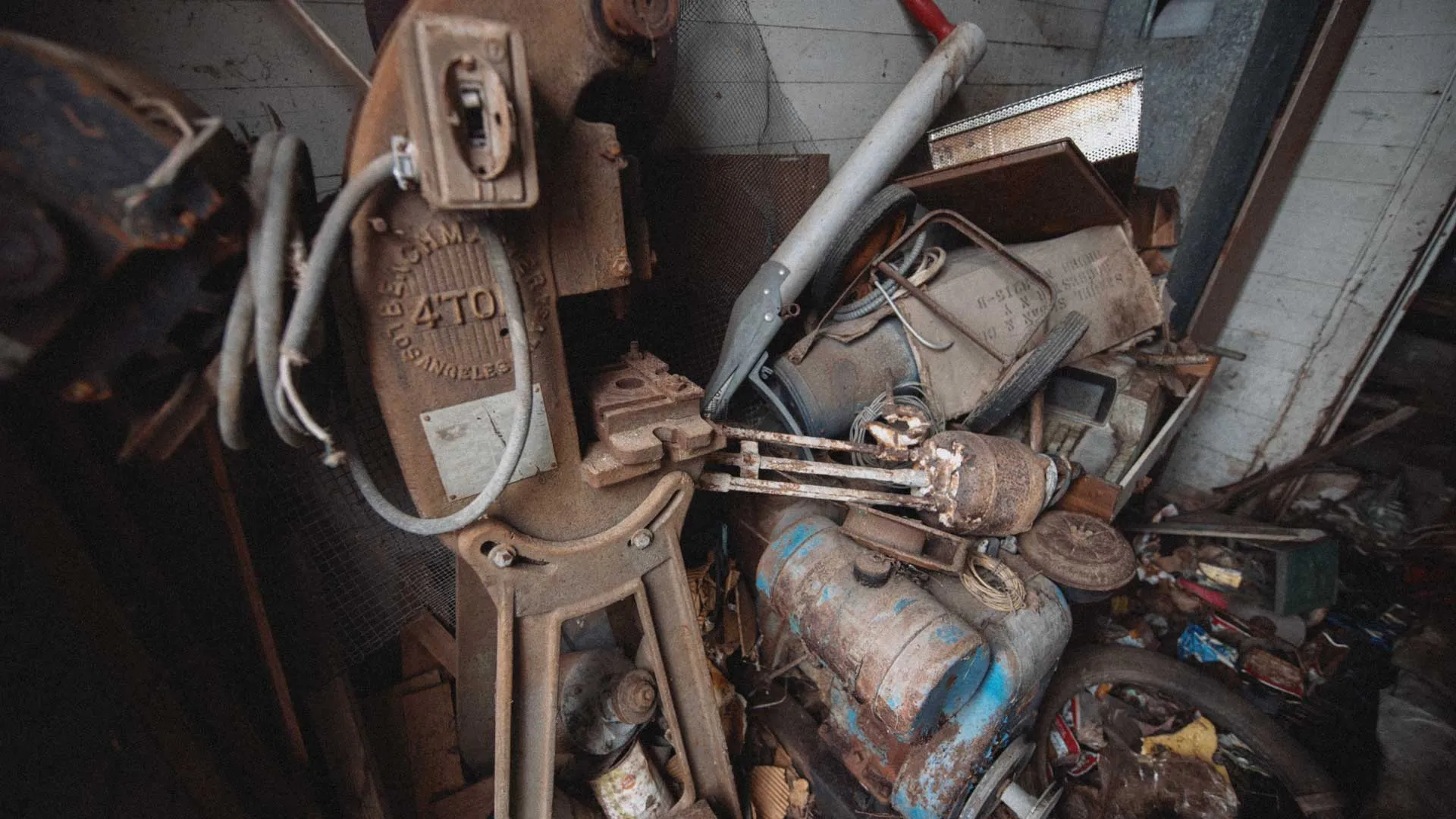 Side entrance of Wiscoy School packed with a vintage bandsaw and small engine